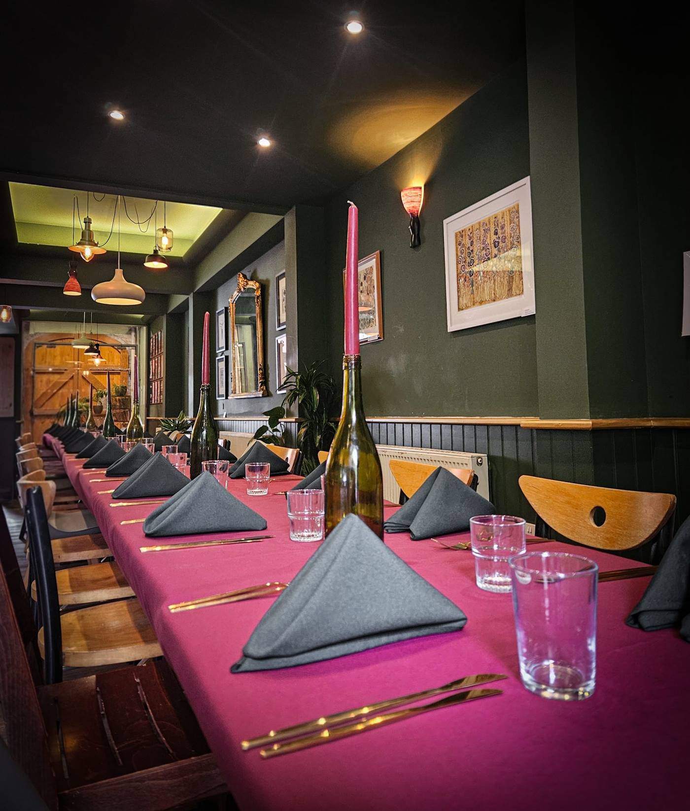 The refurbished dining room with plants and pendant lights
